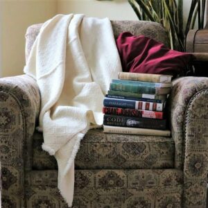 One of our Yogo Wool Blankets draped over the back of an arm chair.