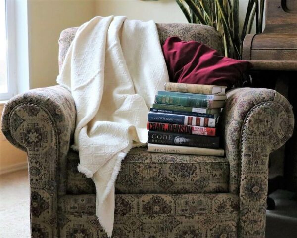 One of our Yogo Wool Blankets draped over the back of an arm chair.
